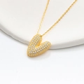 Macro shot of 925 silver gold-plated heart pendant with brilliant pave crystals - 925 Silver / Gold (Initial V)