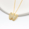 Macro shot of 18K gold plated bubble initial W pendant with sparkling zircon micro-pave - 925 Silver / Gold (Initial W)