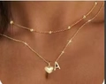 Close-up of gold layered necklace with satellite chain, heart pendant and letter A - Style 2 (A) / Gold