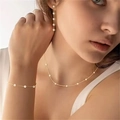 Elegant gold pearl jewelry set including a necklace, bracelet and drop earrings on model - Bracelet / Steel