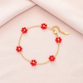 Detail of red beaded flower charms on gold stainless steel chain with lobster clasp closure - Red