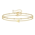 Close-up of golden layered bracelet with letter A pendant and sparkling crystal end - Letter A / Gold