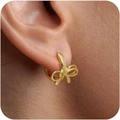 Macro shot of elegant golden bow huggie earrings worn on a model for a festive look - Double Loop Bowknot Huggie (Style Four) / Gold