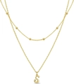 Detail of layered gold beaded necklace featuring a sparkling crystal and letter S pendant - Letter S
