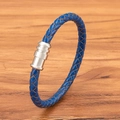 Blue braided leather bracelet with a polished silver magnetic clasp on wood - Blue Leather Steel Clasp