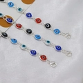 Three colorful Evil Eye bracelets with silver chains and enamel beads on white satin - Silver Multicolor Bracelet
