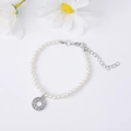 Elegant white pearl bracelet with a sparkling crystal-encrusted round charm and silver clasp - Letter O / Silver
