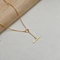 Detail of a minimalist gold-plated silver toggle necklace with a T-bar and ring clasp - Toggle Chain / Gold