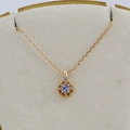 Detailed macro view of gold hollow geometric pendant with square purple tanzanite stone - Tanzanite Necklace