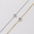 Detail of silver and gold link chains featuring round bezel-set sparkling carbon diamonds - 0.1ct Moissanite / Gold