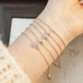 Detailed comparison of five gold chain bracelets with varying diamond sizes on a model wrist - X-Small (Size 1) / Gold