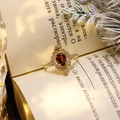 Macro shot of vintage gold-plated ring featuring pear-cut red garnet and intricate filigree - Size 5 (US) / Red Garnet (Gold Band)