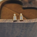 Macro view of gold-plated S925 silver stud earrings with baguette-cut zircons and milgrain edges - T-Shape Baguette Stud Earrings