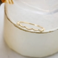 Macro shot of gold wave ring band with milgrain beaded edge details for stacking - US 5 / Wave Milgrain Style