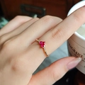 Detailed macro view of S925 silver V-shaped ring with dual red heart rubies worn on finger - US 5 / Gold