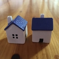 Close-up of miniature white resin houses with blue roofs on a wooden surface - 3.5cm / Purple