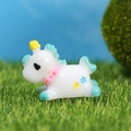 Miniature unicorn figurine with blue mane and yellow stars on green artificial turf - Green