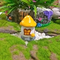 Detailed view of yellow resin mushroom house miniature with white spots and stone base - Yellow