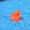 Miniatuur oranje eendje van hars voor moslandschap decoratie op blauw zandbed - Oranje
