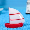 Miniatur Segelboot aus rotem Harz auf blauem Sand für Meeres-Mikrolandschaften - Mittel / Weiß