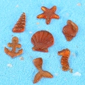 7-piece set of amber orange resin ocean charms including seahorse, starfish and shells - Orange