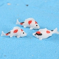 Trois figurines de carpes koi en résine pour micro-paysage sur fond de sable bleu - Poisson Rouge Blanc