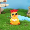 Cute yellow resin duckling figurine wearing a red graduation cap and sunglasses - Yellow Graduation Duck With Book (4号)