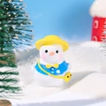 Miniature resin snowman figurine with yellow hat and blue coat in a snowy winter scene - Snowman with Yellow Hat