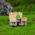Miniature cottage ornament with thatched roof and blue window on green moss base - Style 2 (Grey Wall with Leaves)