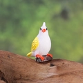 Miniature white and yellow resin bird figurine perched on log for micro landscape - Purple