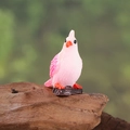 Pink and white miniature parrot figurine perched on a brown stump for micro landscape - Pink