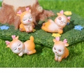 Detailed view of four resin deer figurines with heart antlers on a mossy forest background - Four Style Collection