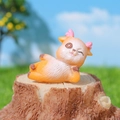 Cute resin deer figurine in orange and white, winking and lying on a wooden stump - Winking Side Lying Deer Style B