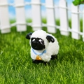 Miniature resin sheep ornament with curly wool texture and blue collar on green grass - Black Mouth Sheep