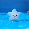 Light blue resin starfish with glitter finish and cute smiley face for DIY crafts - Starfish