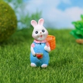 Miniature resin rabbit figurine wearing blue overalls with an orange flower basket - Blue Rabbit With Back Basket