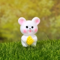 Miniature resin mouse figurine with pink ears holding yellow cheese on green grass - White Rabbit