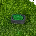 Miniature micro landscape ornament with black rock base and lush green grass detail - Sheep Feeding Trough