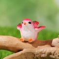 Miniature pink and white resin bird figurine with spread wings on a wooden branch - Spreading Wings Pink White Style (A)