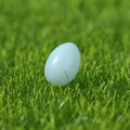Pastel blue resin Easter egg ornament with a matte finish on green grass - Blue Easter Egg