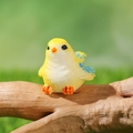 Miniature yellow resin bird figurine with blue wings perched on a wooden branch - Sitting Yellow Blue Wing Style (G)