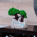 Miniature landscape ornament with green pine trees and blue stream on a rock base - Style B