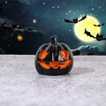 Glossy black Halloween pumpkin resin charm with glowing orange evil smile design - Spooky Gaze Pumpkin