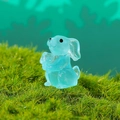 Glow-in-the-dark light blue rabbit figurine miniature on green moss garden decor - Luminous Blue