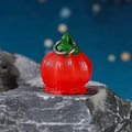 Red persimmon shaped glowing garden ornament with green leaves on a rock base - Glow Red Lantern