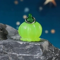 Luminous green lantern flower pendant on stone with soft blue bokeh background - Glow Green Lantern