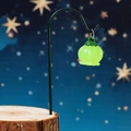 Luminous green lantern flower pendant hanging on a metal stand with wood base - Glow Green Lantern With Iron Hook