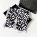 Elegant black and white geometric pattern square silk scarf on a luxury tray - Black and White