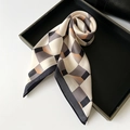 Elegant silk scarf featuring geometric diamond patterns in cream, charcoal, and orange - Black