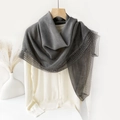 Detailed view of dark grey shawl with elegant lace trim hanging on a wooden hanger - 100*100cm / Gray